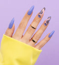 Nail styling in blue shade with a touch of violet and bold patterns
