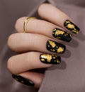 Black nails with golden accent for special occasions