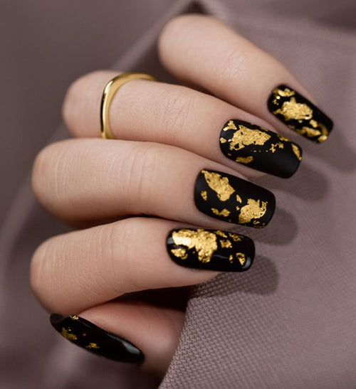 Black nails with golden accent for special occasions