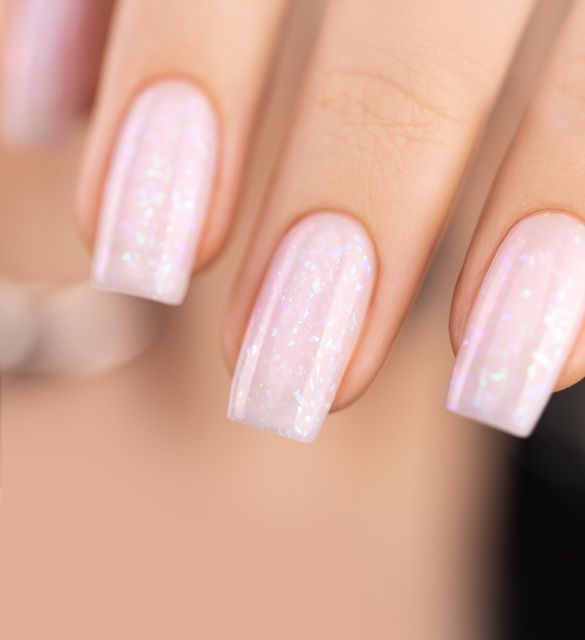 Milky pink hybrid base for nails with turquoise foil shimmer